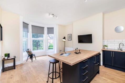 Bright, modern open-plan living space with a la...