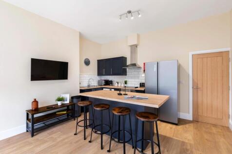 Modern open-plan kitchen with a central island ...