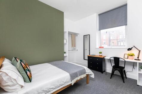 Bright, modern bedroom featuring a comfortable ...