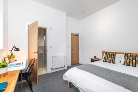 Bright, neatly presented bedroom with a comfort...