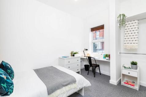 Bright, neatly styled bedroom featuring a doubl...