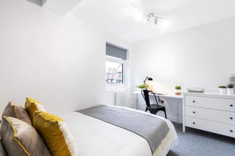 Bright, neatly presented bedroom with modern wh...