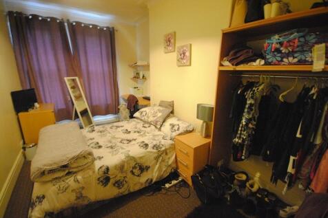 Cozy furnished bedroom with a double bed, built...