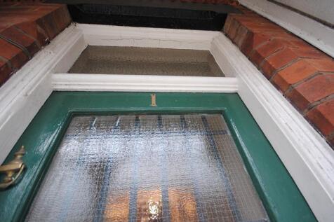 Attractive traditional front entrance with a gr...