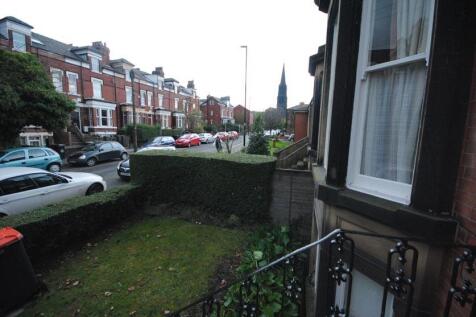 Street view of a residential terrace with a sma...