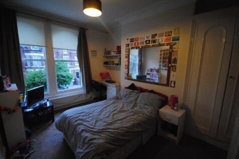 Cozy furnished bedroom with a large bed beneath...