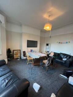 Spacious communal living room with multiple com...