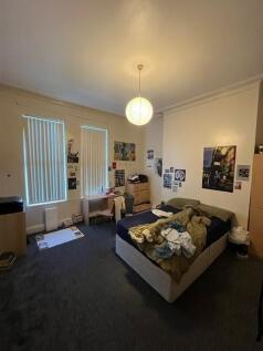 Spacious bedroom with a double bed, desk and st...