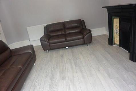 Bright contemporary living room with light wood...