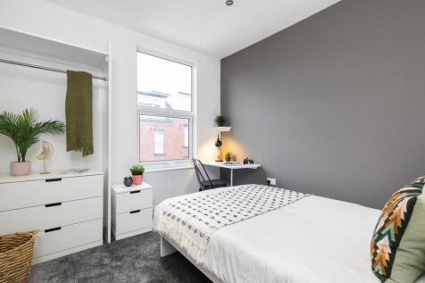 Bright, stylish bedroom with a comfortable doub...