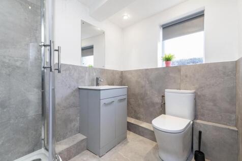 Bright, modern bathroom with a walk-in shower, ...
