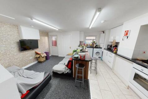 Open-plan living area with a modern fitted kitc...