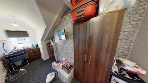 Bright attic double bedroom with a sloped ceili...