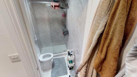 Modern bathroom with a walk-in shower, white to...