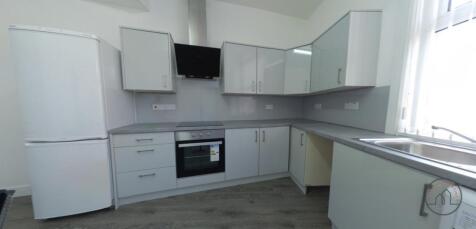 Bright modern kitchen with white high-gloss cab...