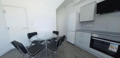 Bright modern kitchen with a glass dining table...