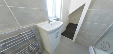 Bright, modern bathroom with a compact vanity u...