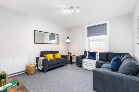 Bright, modern living room with two comfortable...