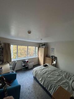 Bright double bedroom with a large front window...