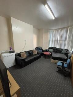 Bright communal lounge with multiple leather so...