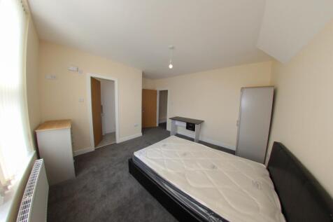 Bright, spacious bedroom with a double bed, lar...