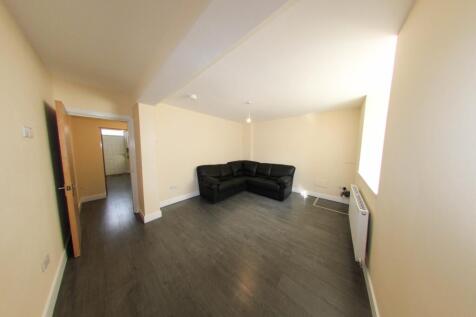 Well-presented living room with pale walls, dar...