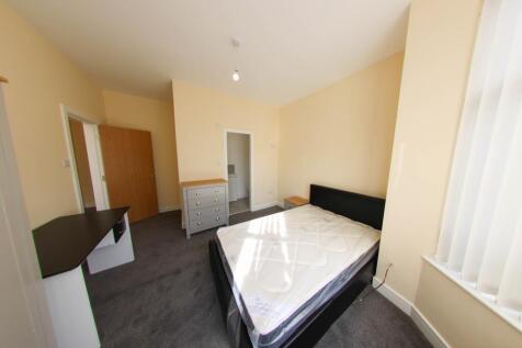 Bright, neutrally decorated double bedroom with...