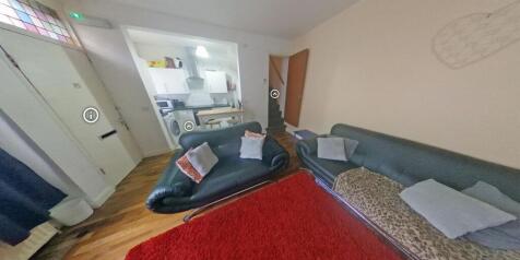 Bright, inviting living room with leather sofas...