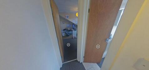 Narrow internal hallway with two open doors lea...