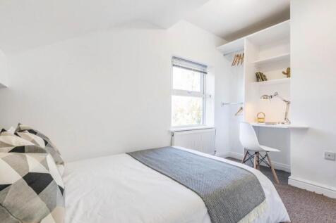 Bright, neatly presented bedroom with a comfort...