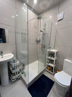 Modern bathroom with large corner glass shower ...