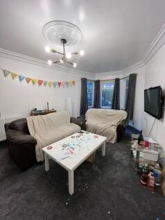 Comfortable communal living room with two sofas...