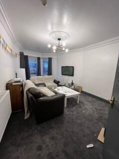 Comfortable communal living room with sofas, wa...