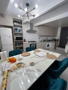 Bright modern kitchen with a marble-effect dini...