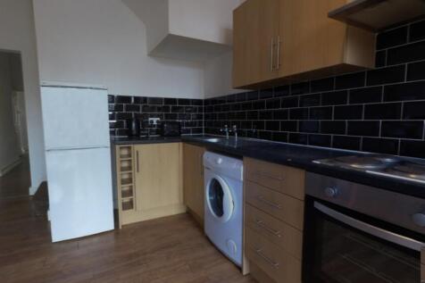 Modern galley-style kitchen with dark subway-ti...