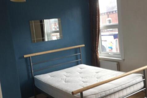 Bright, simply furnished bedroom with a double ...