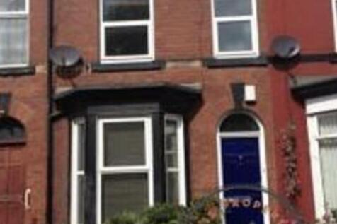 Red-brick terraced house with bay window and a ...