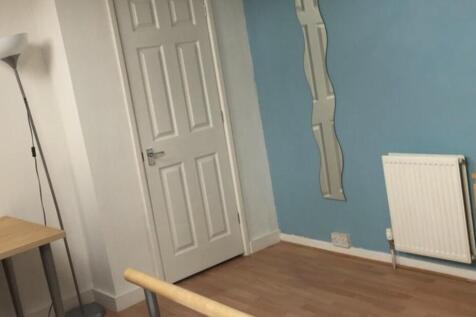 Neat bedroom with light blue feature wall, wood...