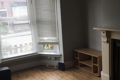 Bright front-facing living room with a bay wind...