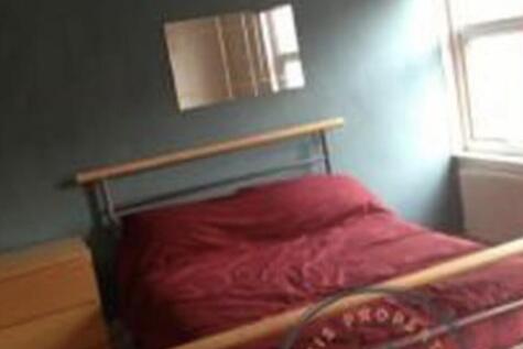 Bright double bedroom with a metal-frame double...