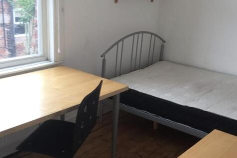 Bright, simply furnished bedroom with a large d...