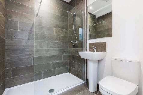Modern ensuite-style bathroom with a walk-in gl...