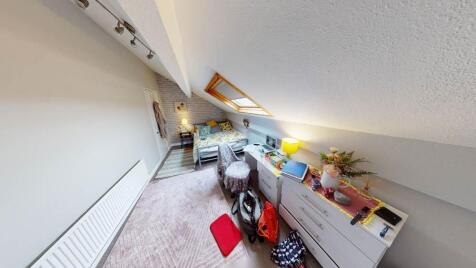 Cozy attic single bedroom with a sloped ceiling...