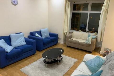 Bright, neatly furnished living room with comfy...