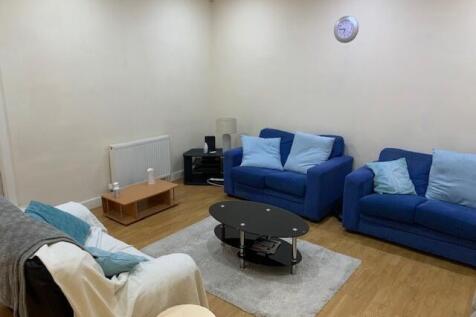 Bright, neatly presented living room with match...