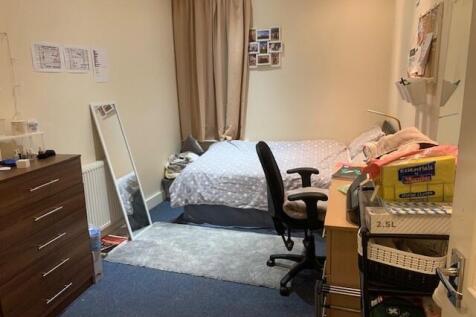 Cozy furnished bedroom with a single bed, study...