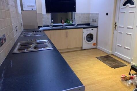 Long galley-style kitchen with a full-length co...