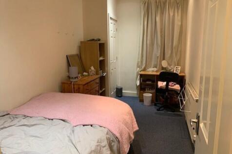 Cosy furnished bedroom with a double bed, bedsi...