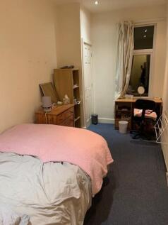 Bright bedroom with a double bed, desk workspac...