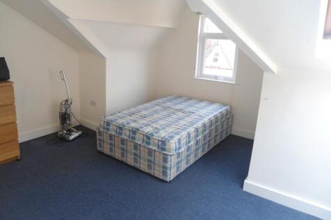 Bright attic-style bedroom with a single mattre...